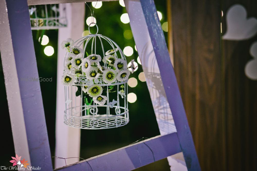 Photo of White birdcage with flowers