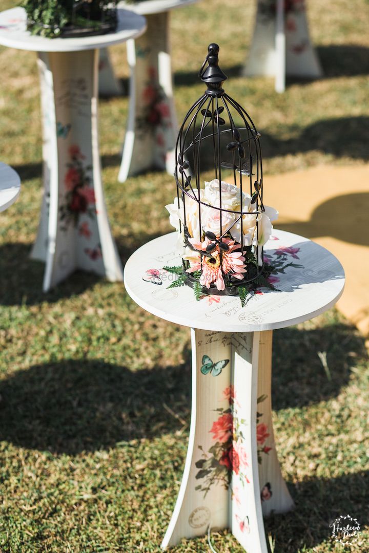 Photo of Unique table with floral print and birdcage