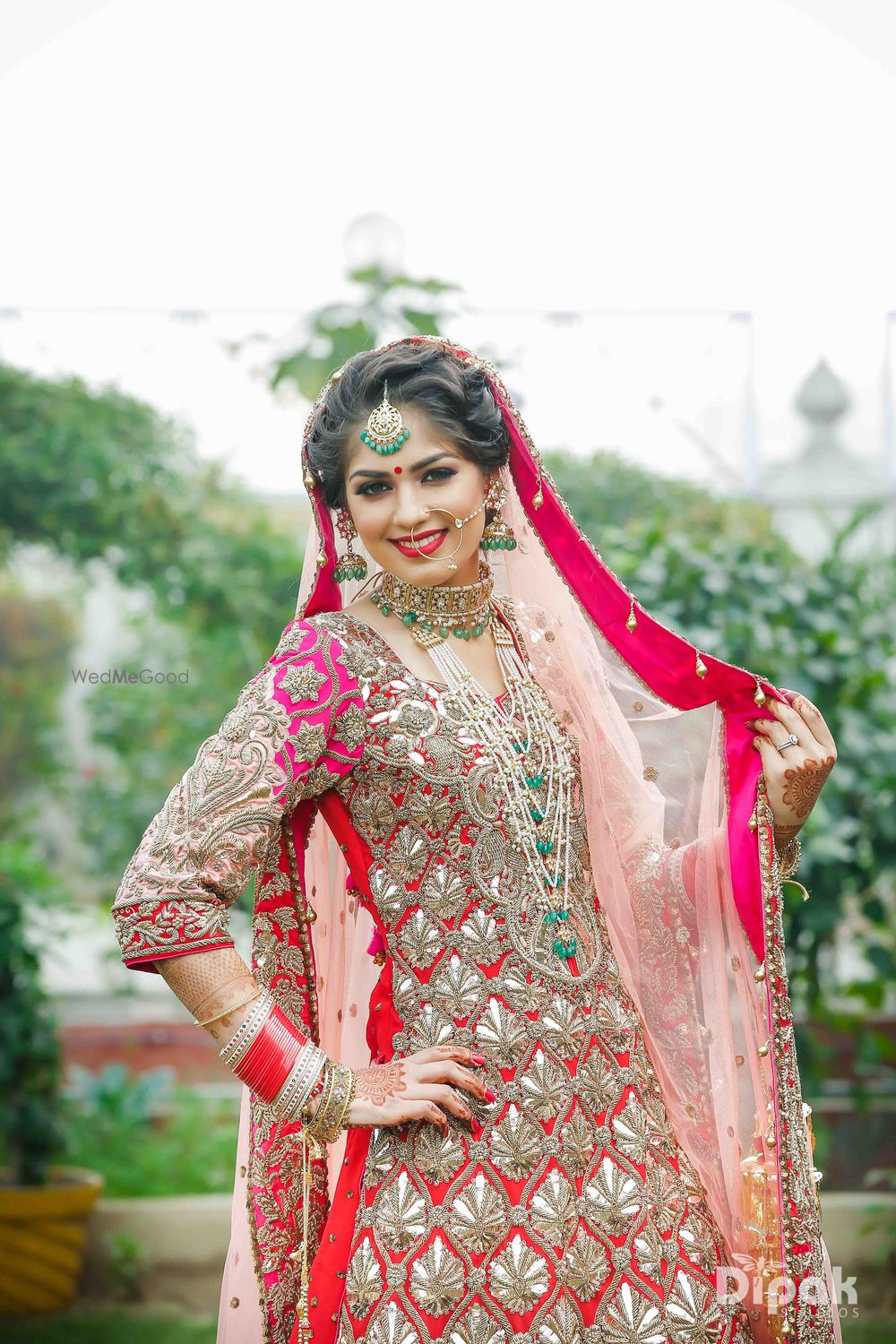 Photo of Layered bridal contrasting jewellery in green with satlada and choker