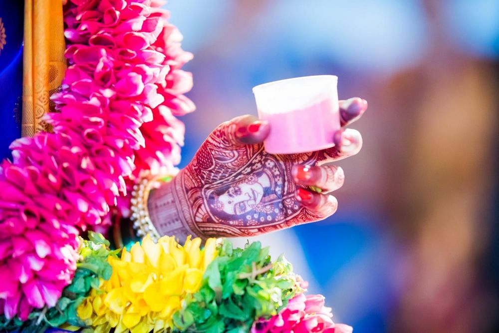 Photo of Mehendi design with bridal portrait and bride holding cup