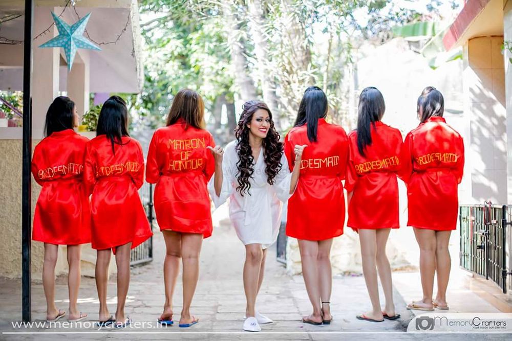 Photo of Bride with coordinated bridesmaids in robes