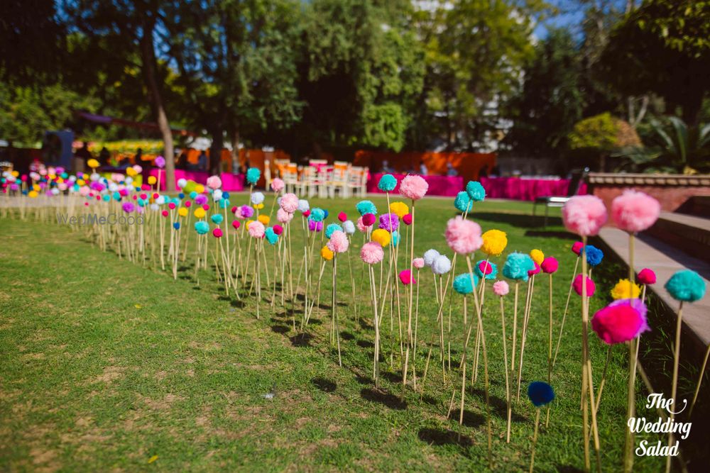 Photo of Pom poms in mehendi decor