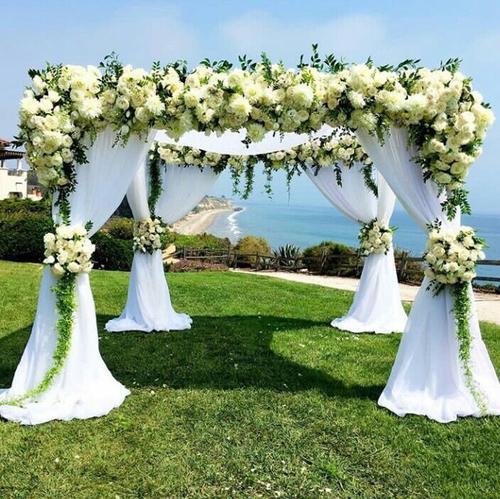 Photo of White and green floral mandap with drapes