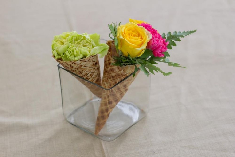 Photo of Unique centrepiece with flowers in ice cream cones