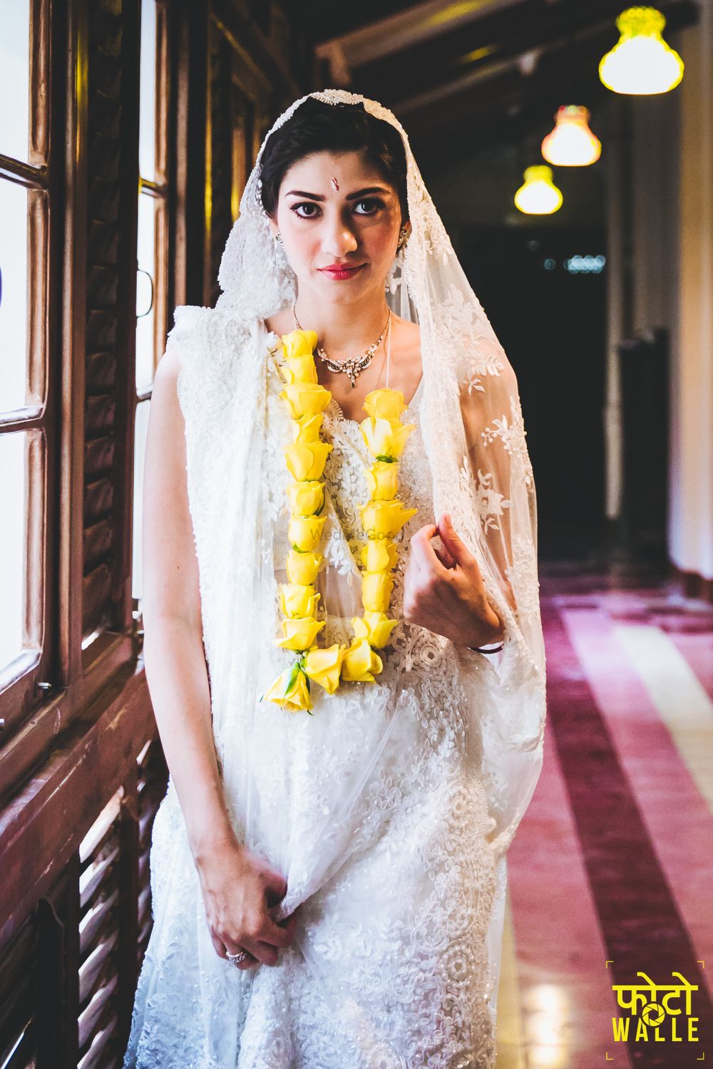 Photo of Parsi bride in white saree with yellow rose jaimala