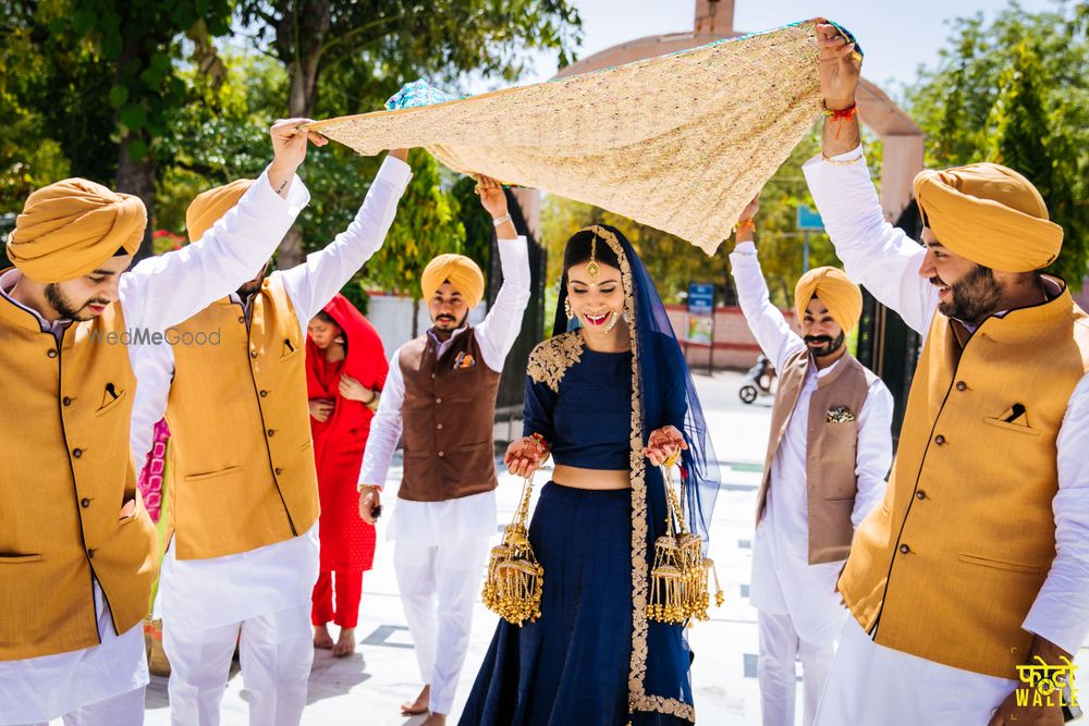 Photo of Bride entering in minimal blue lehenga with groomsmen in yellow