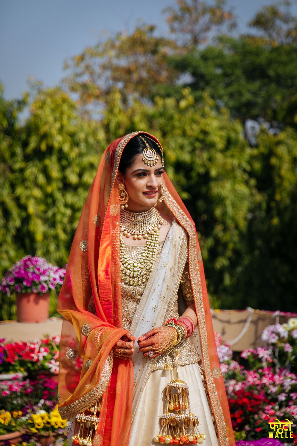 Photo of Bride in orange and gold with unique kaleere