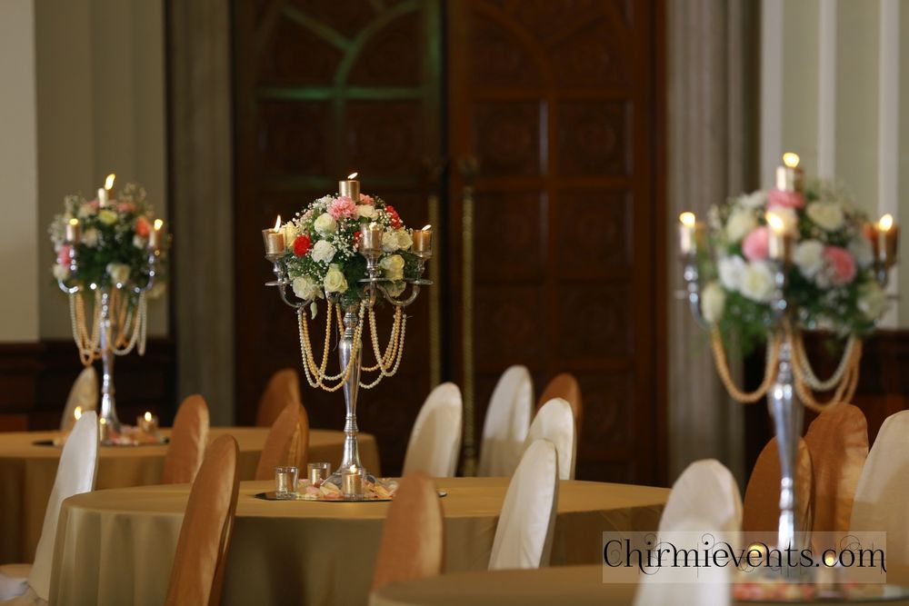 Photo of Tall floral and candle lit table centerpiece