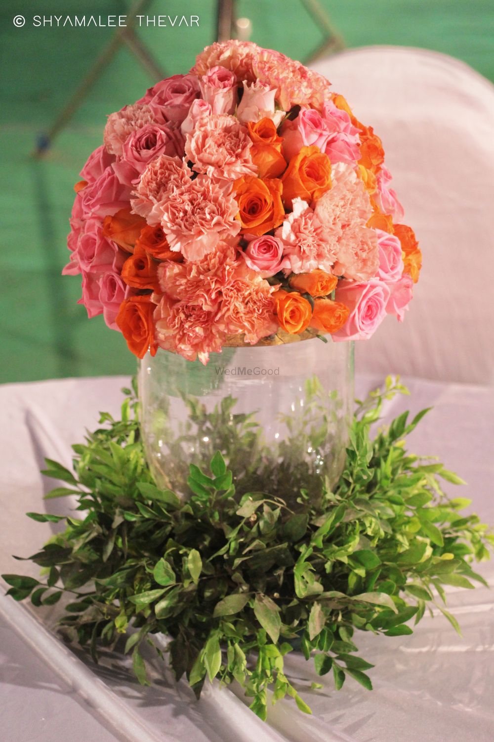 Photo of Floral centrepiece with peach flowers in mason jar
