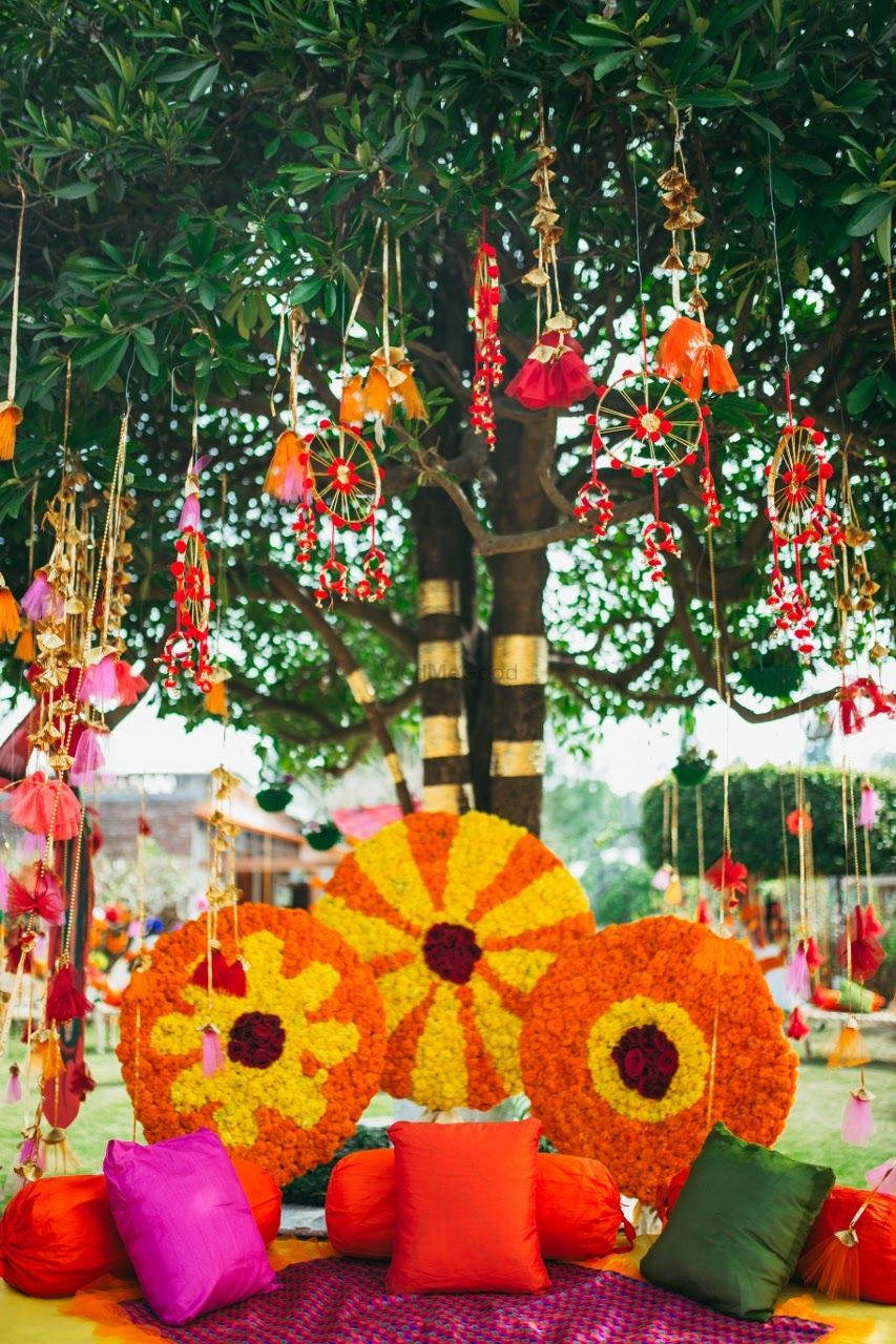 Photo of Coolrful and floral mehendi seating for bride