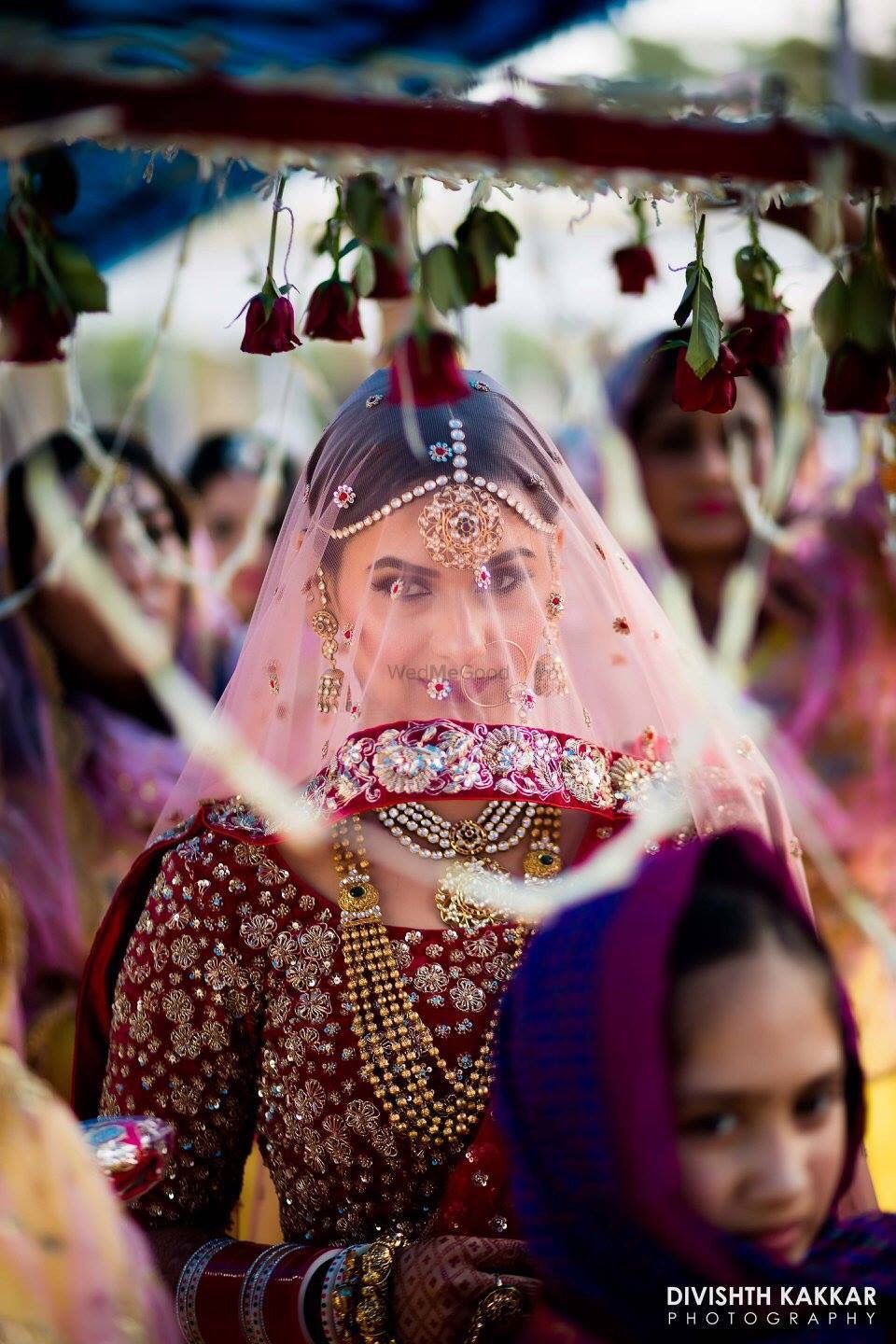 Photo of Bride entering wearing dupatta as veil