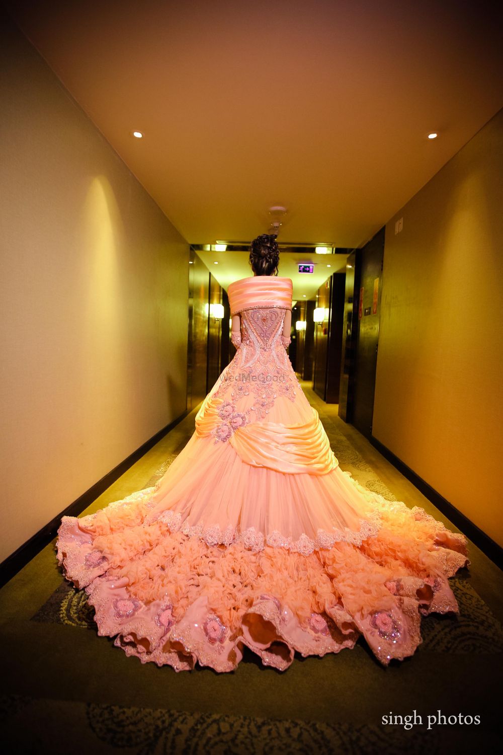 Photo of Dramatic peach sangeet gown with long train