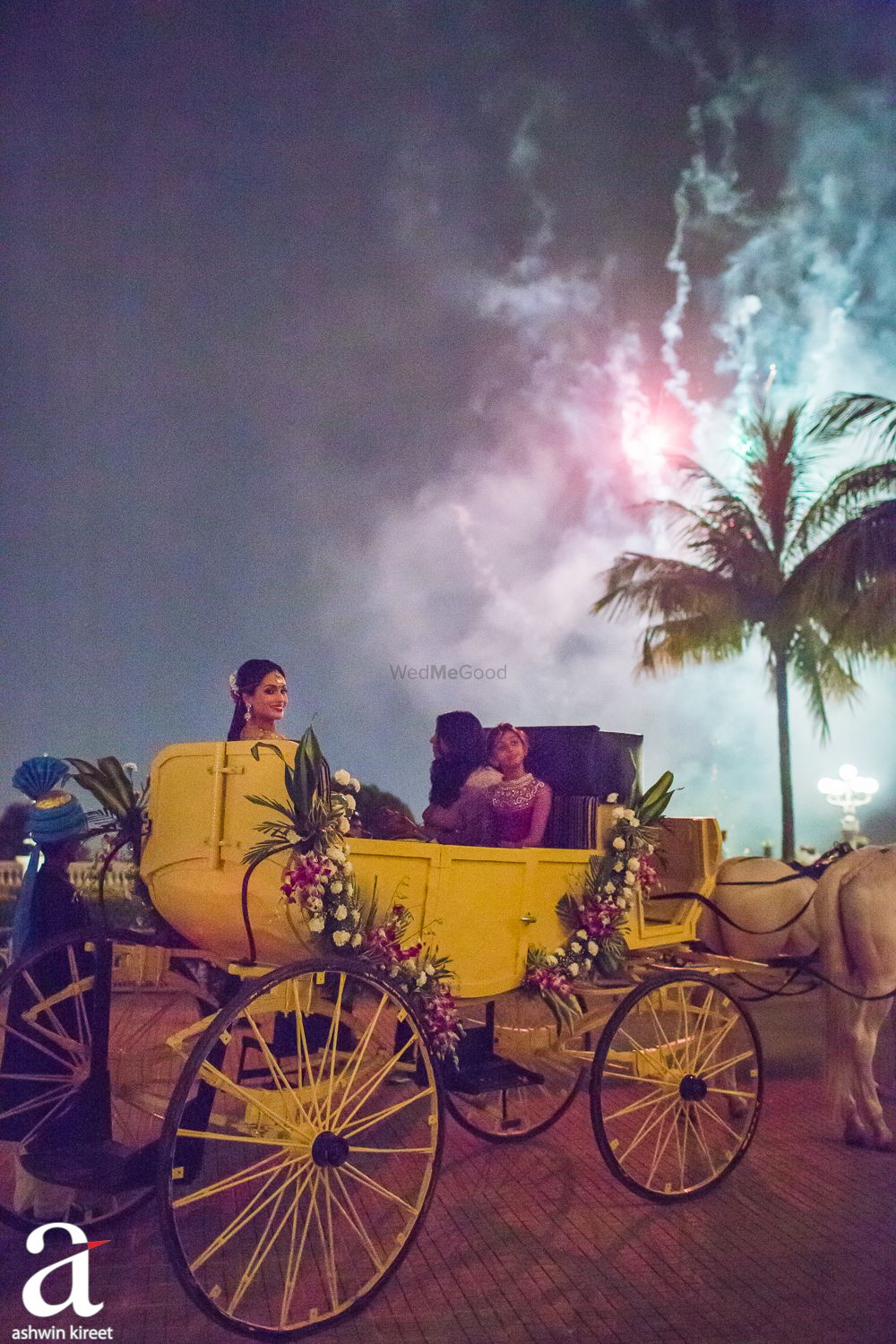 Photo of South Indian bride entry on yellow chariot with florals