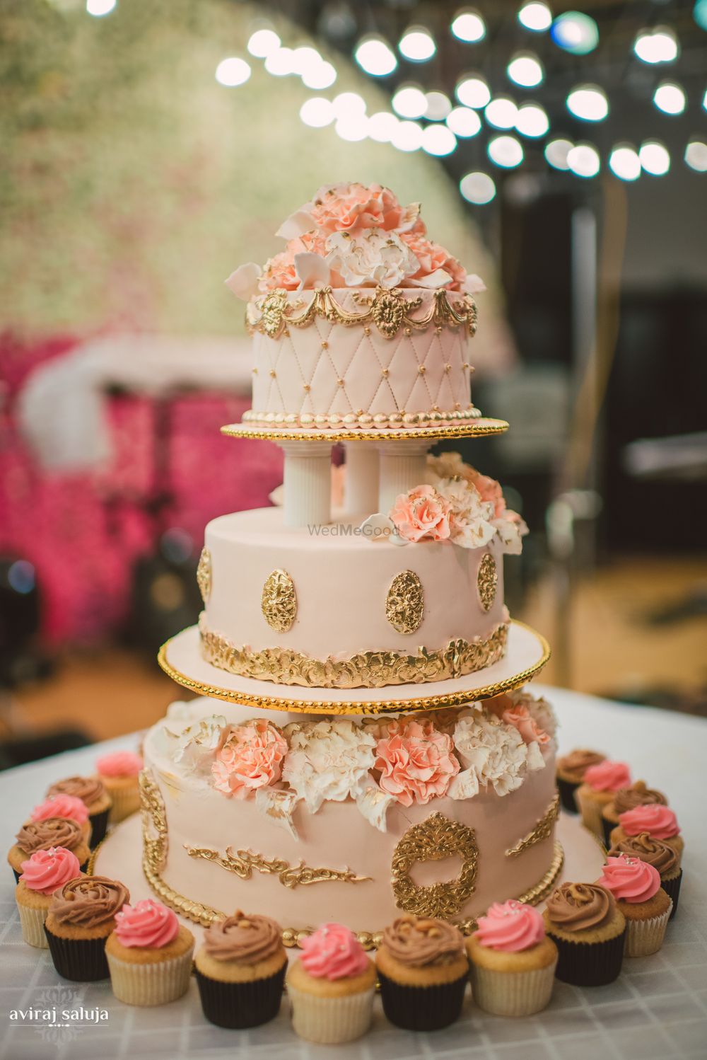 Photo of 3 tier white and peach wedding cake with gold details