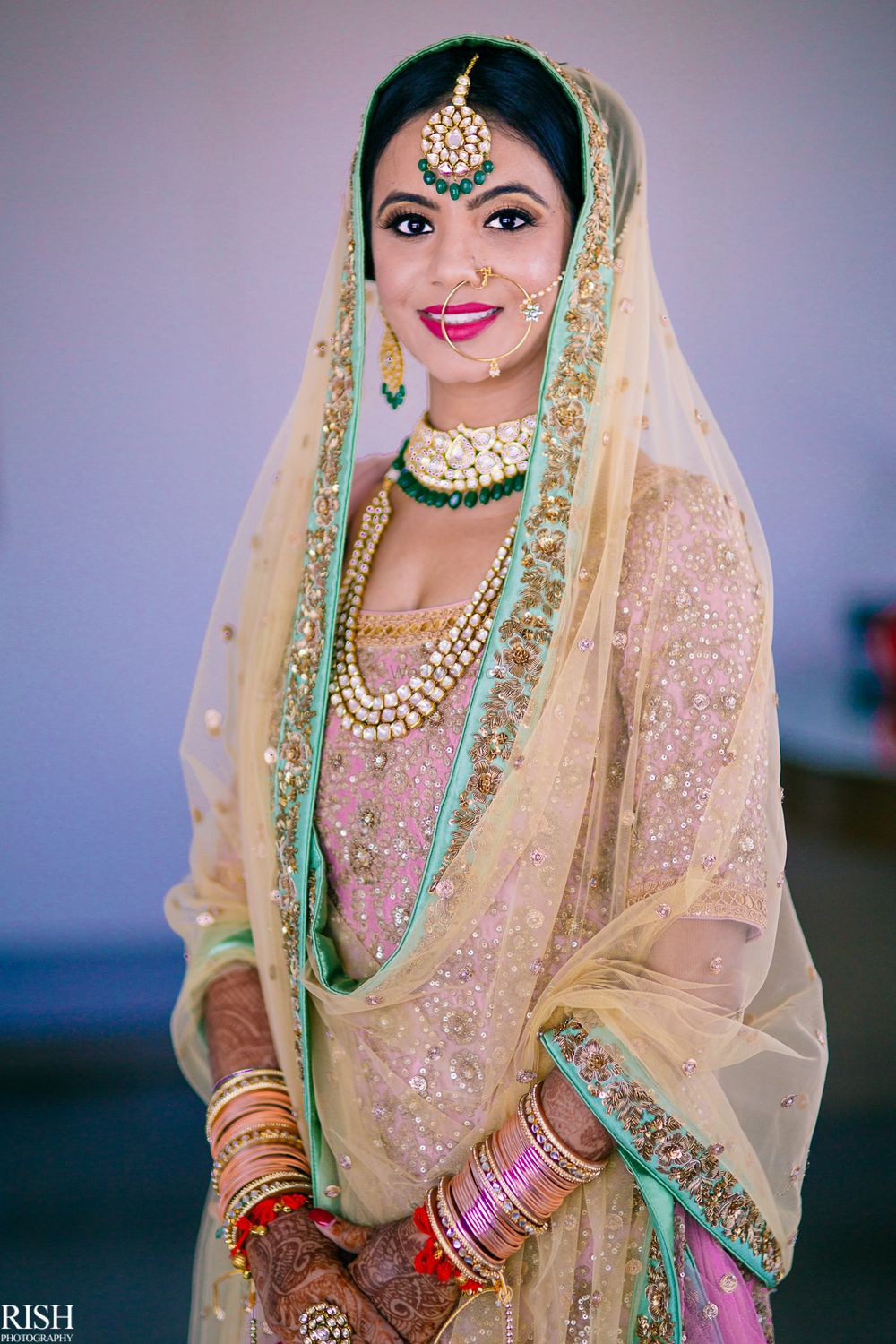 Photo of Sikh bride in pastel lehenga and contrasting jewellery