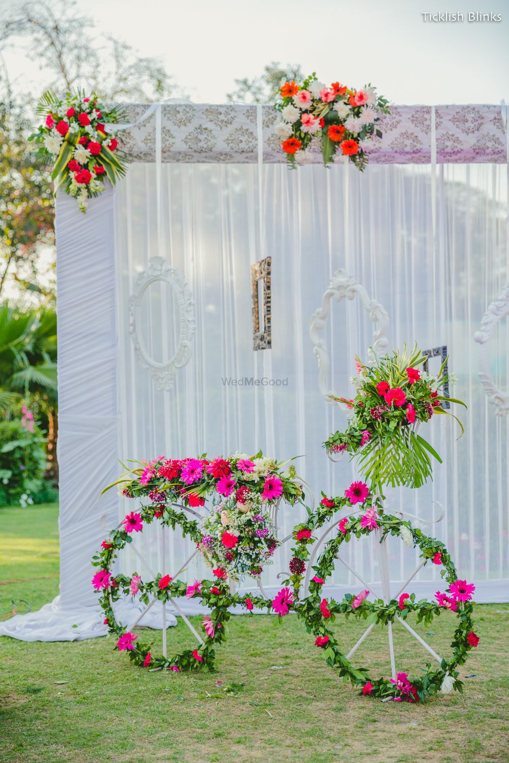 Photo of Bicycle prop with floral arrangement all over in green and pink