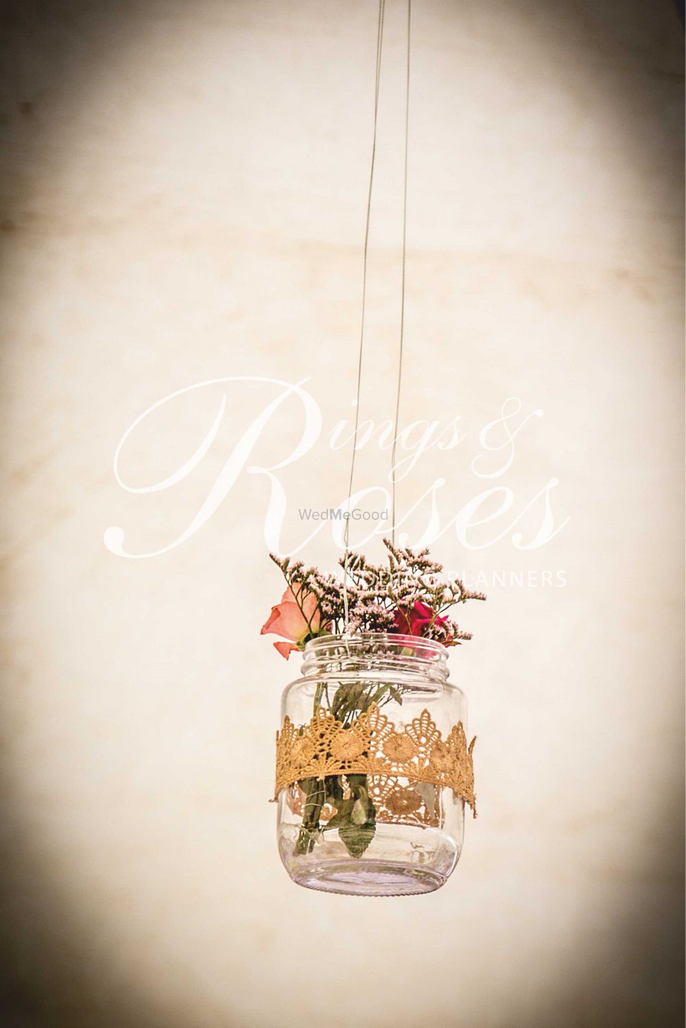 Photo of Hanging glass jars with flowers in decor