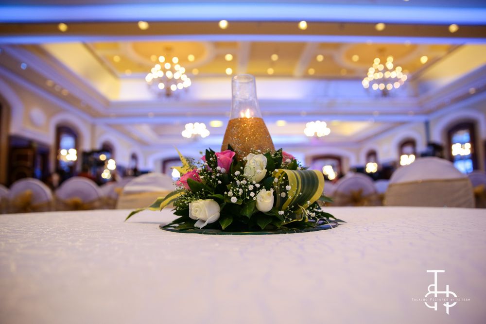 Photo of Floral and candle lit table centerpiece