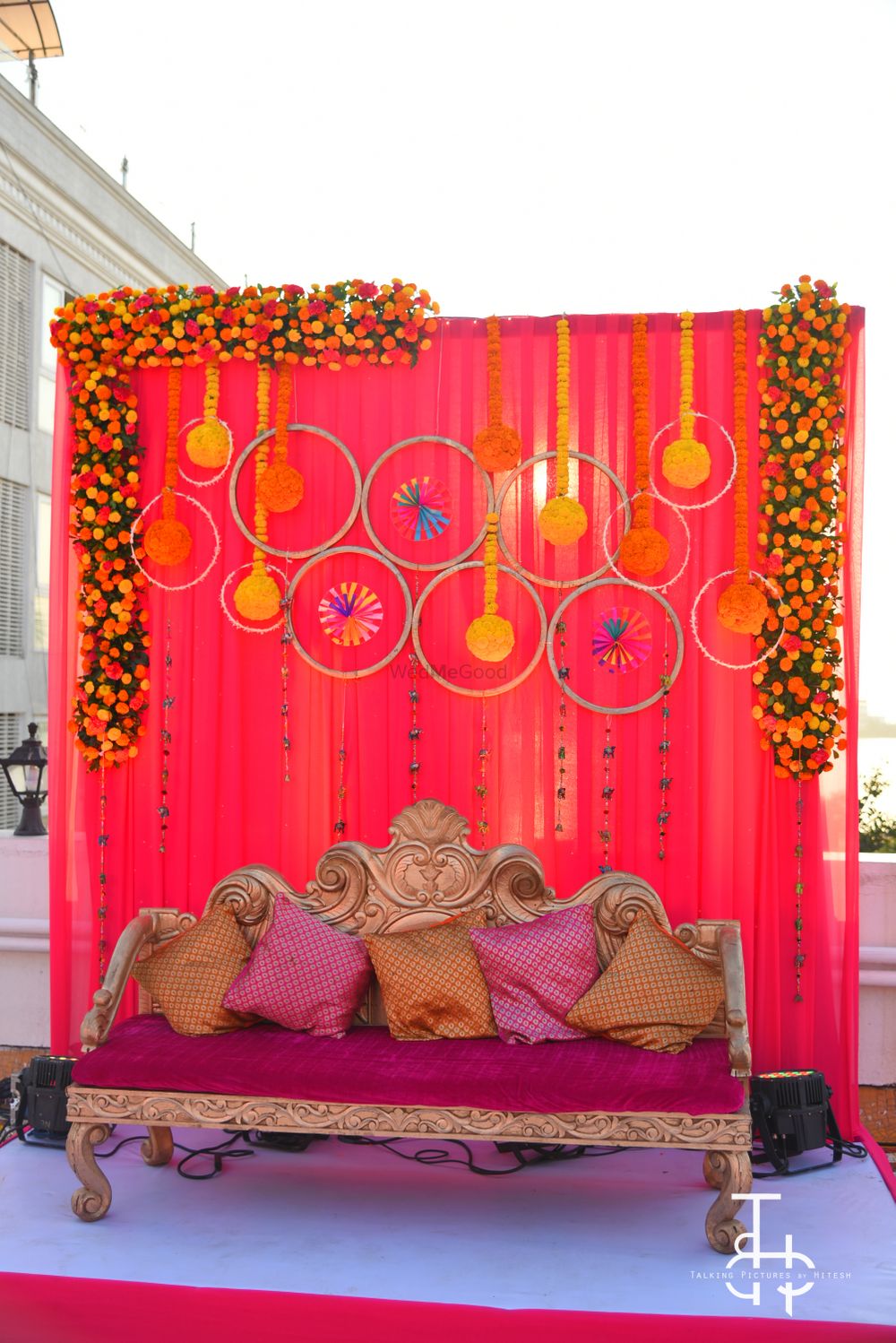 Photo of Bright and floral mehendi stage backdrop