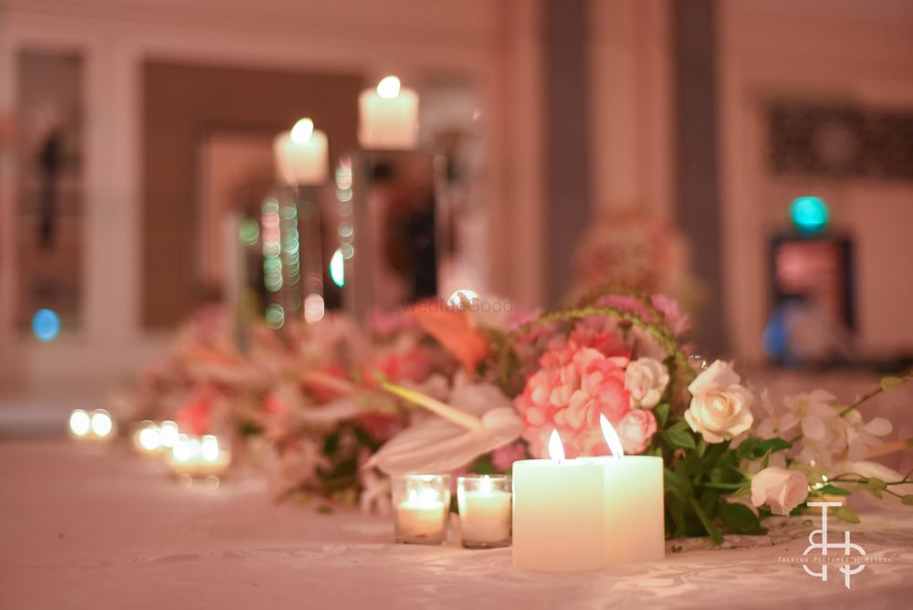 Photo of Flowers and candle lit table setting
