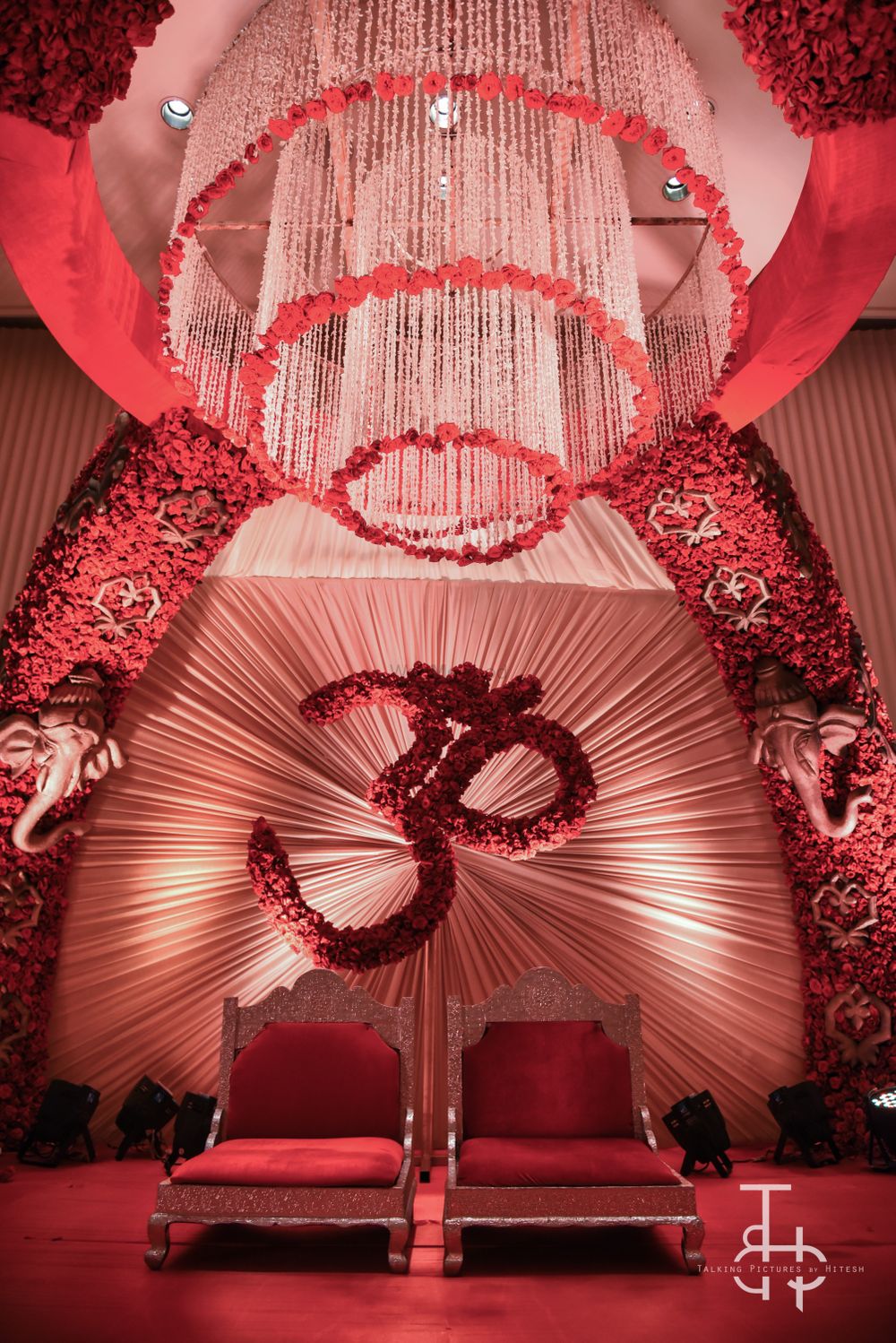 Photo of White and red floral chandelier in wedding decor