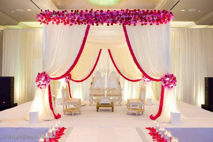 Photo of Indoor mandap decor in pink and white with drapes