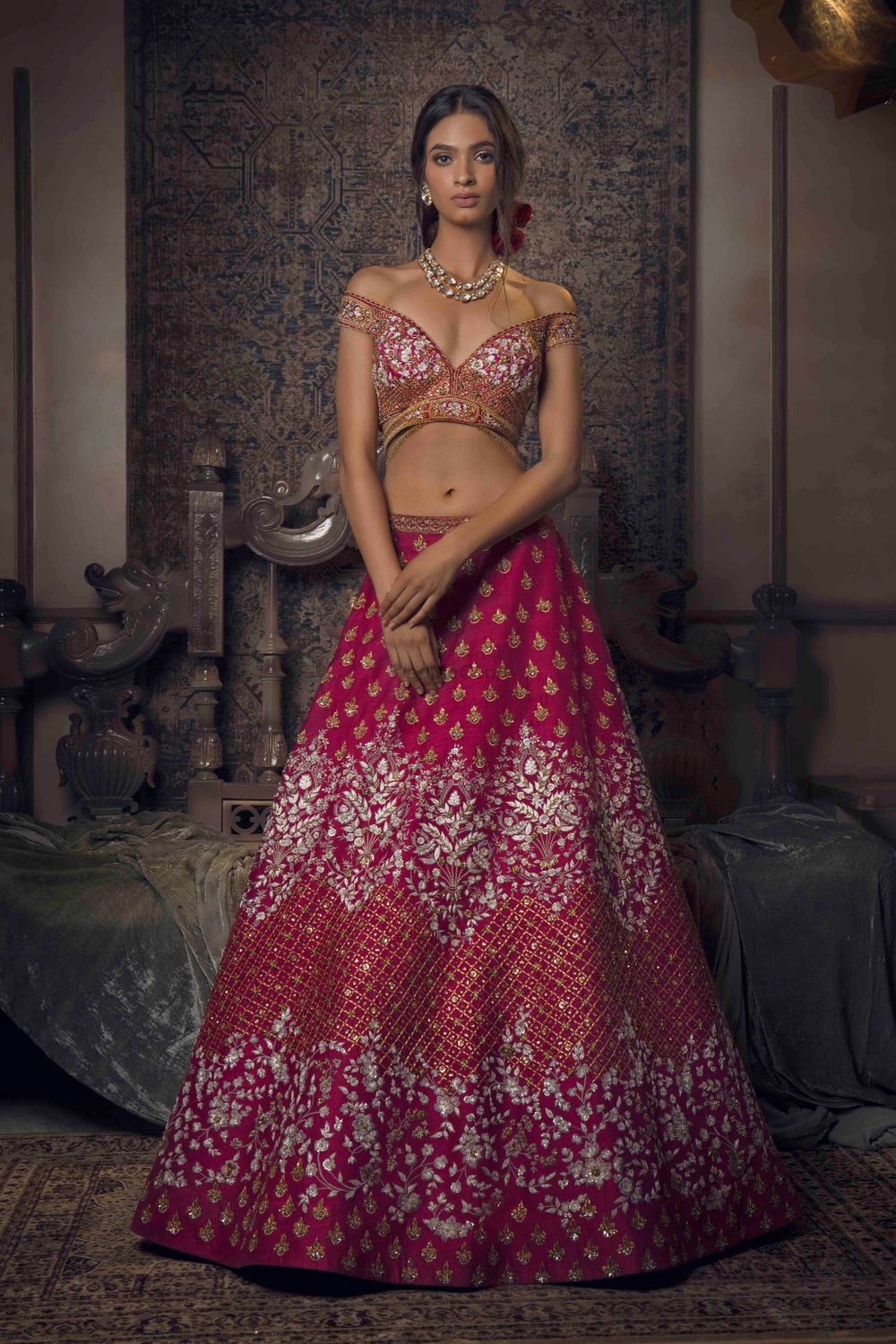 Photo of Bright pink and gold lehenga with off shoulder blouse