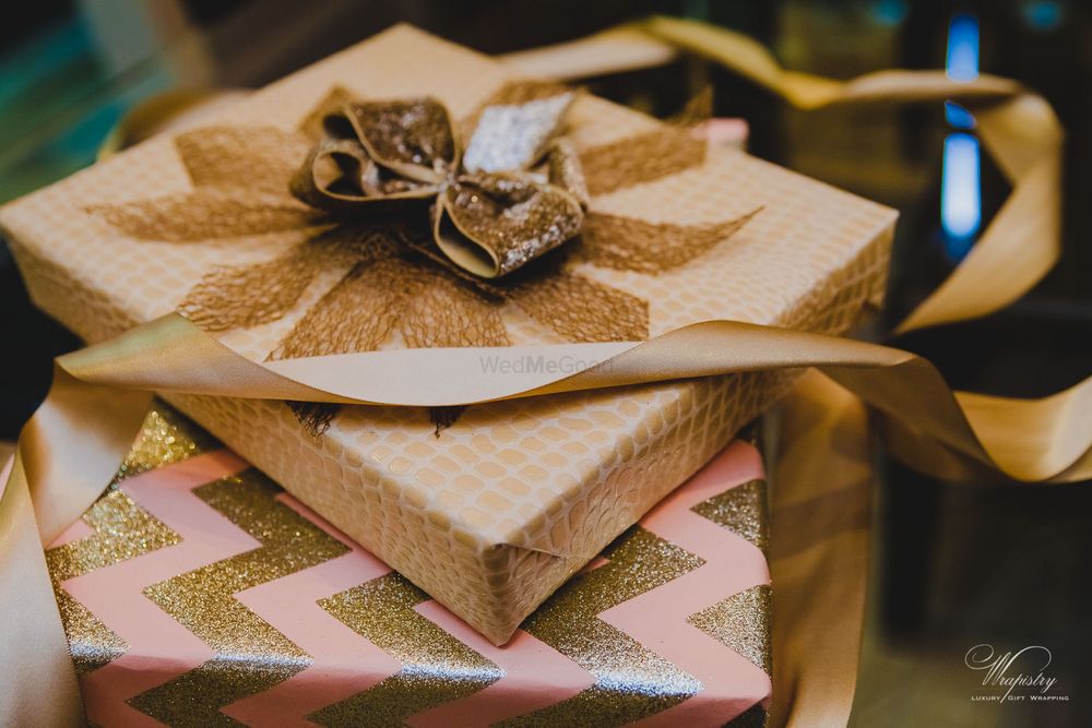 Photo of pink and gold wedding packaging