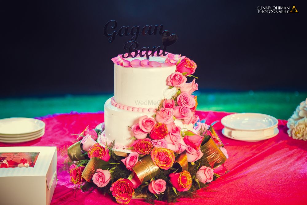 Photo of white two tiered cake with flowers on it