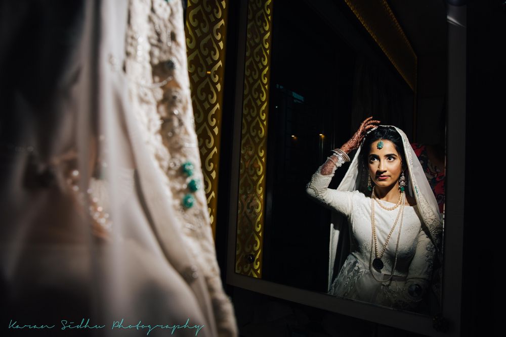 Photo of Pretty bridal portrait looking into mirror