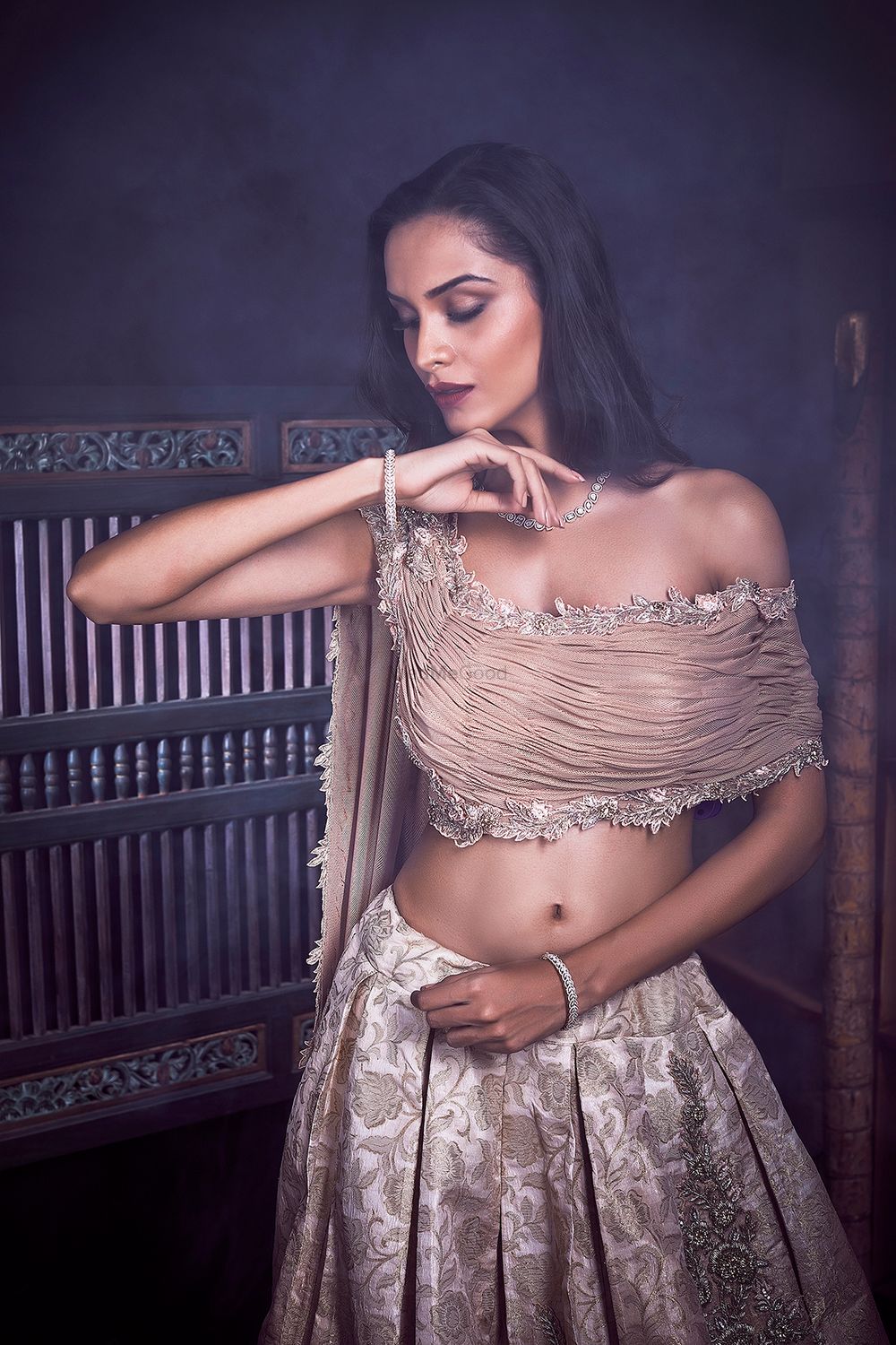 Photo of Modern lehenga in dull gold with off shoulder blouse