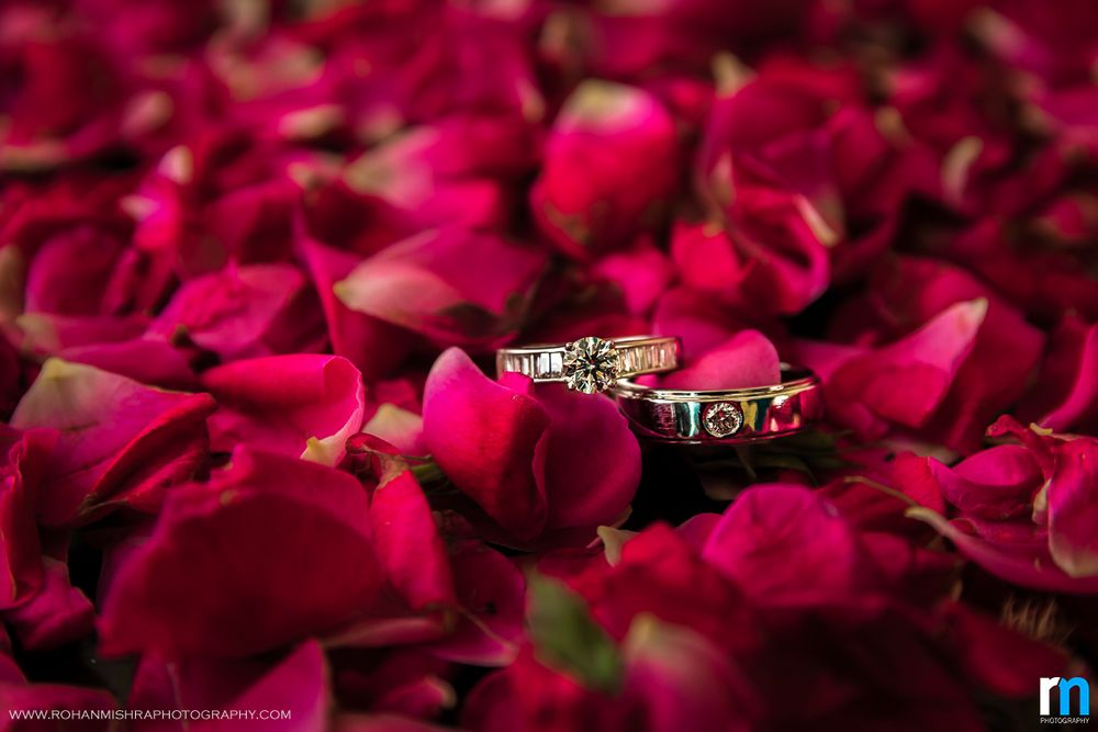 Photo of Couple Diamond Engagement Rings on Rose Petals