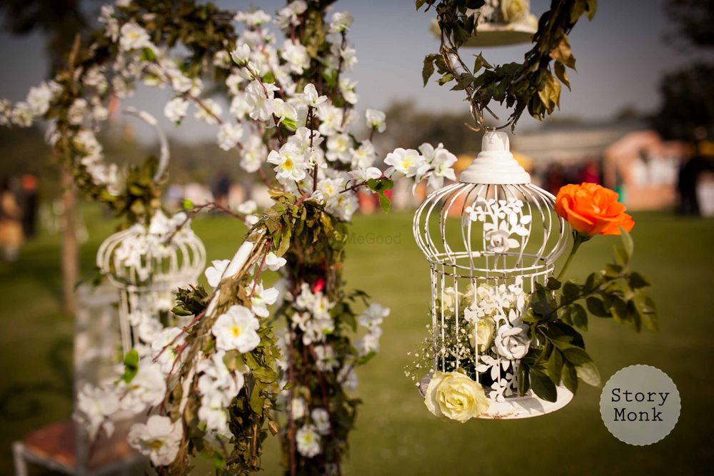 Photo of White floral birdcages in decor