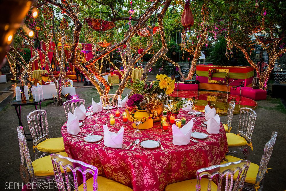 Photo of Bright and colorful table setting for mehendi