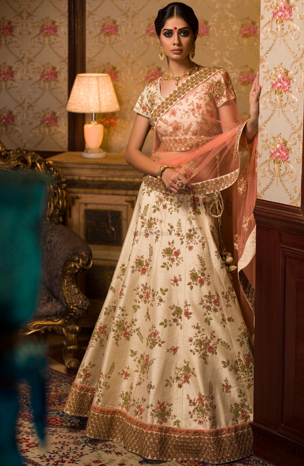 Photo of White floral lehenga with gold borders and peach dupatta for mehendi
