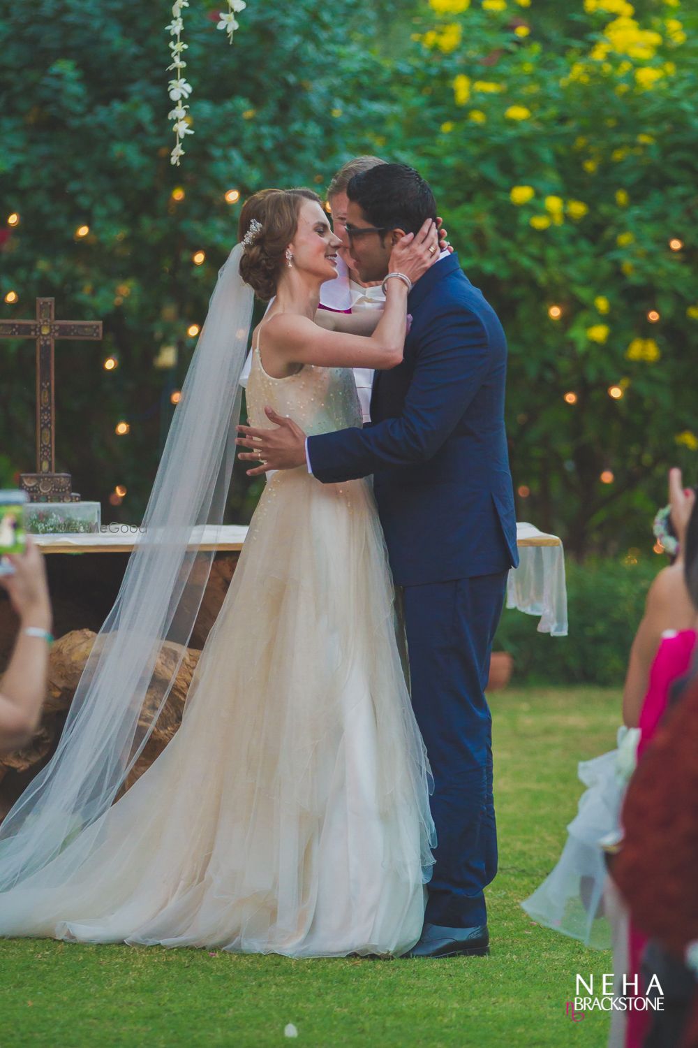 Photo of Couple kissing shot at christian wedding