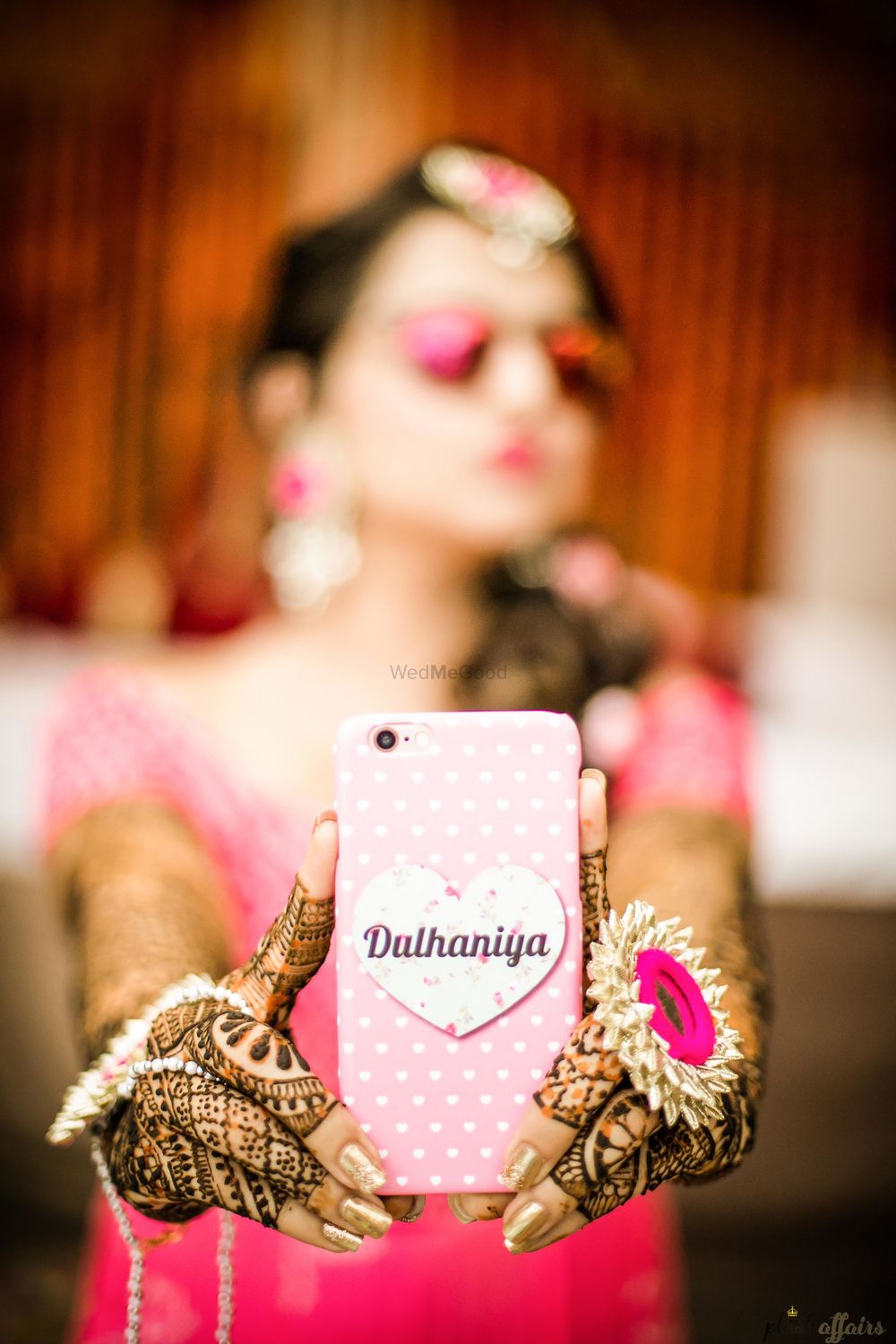 Photo of Bride holding up bridal dulhaniya phone cover