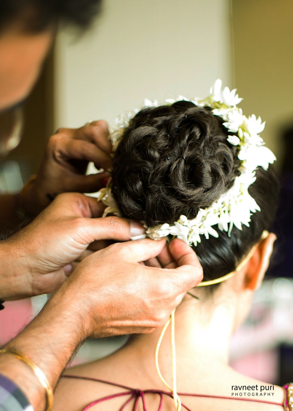 Photo of Bridal bun with braid and white flowers