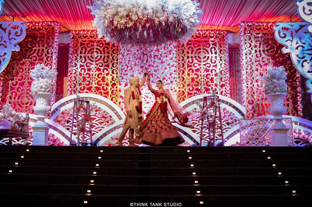 Photo of Groom twirling the bride on wedding day shot