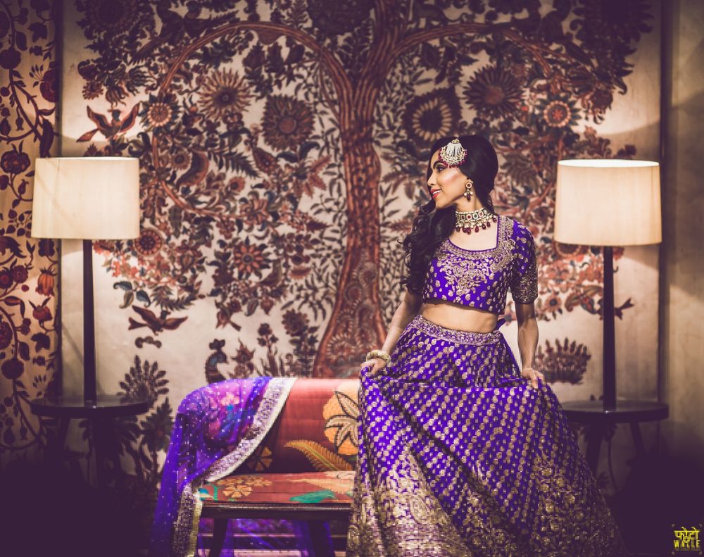 Photo of Bride in purple sangeet lehenga posing