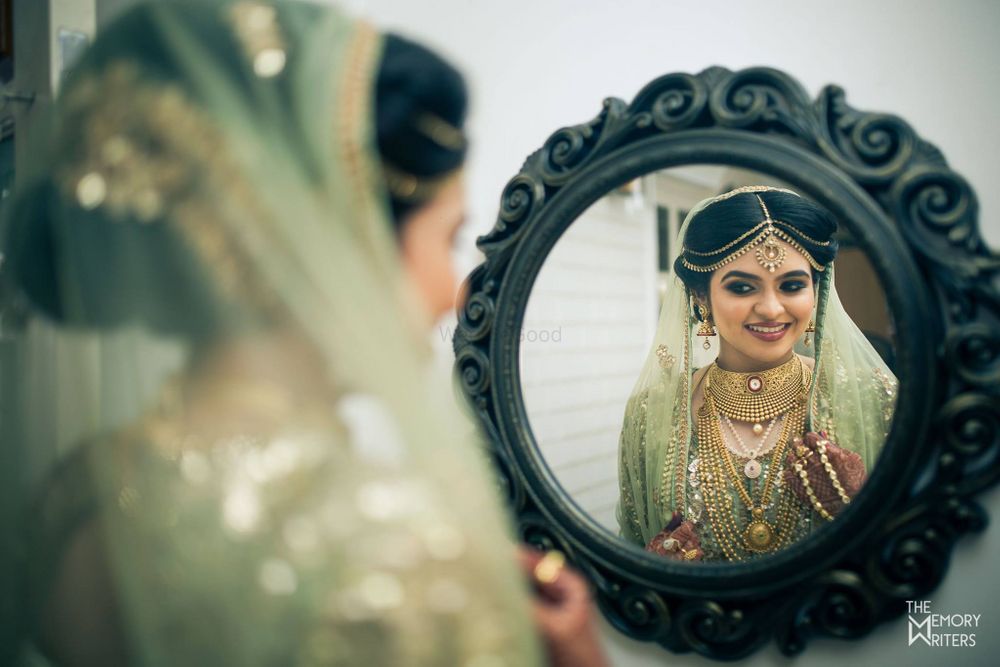 Photo of Bride looking in the mirror shot