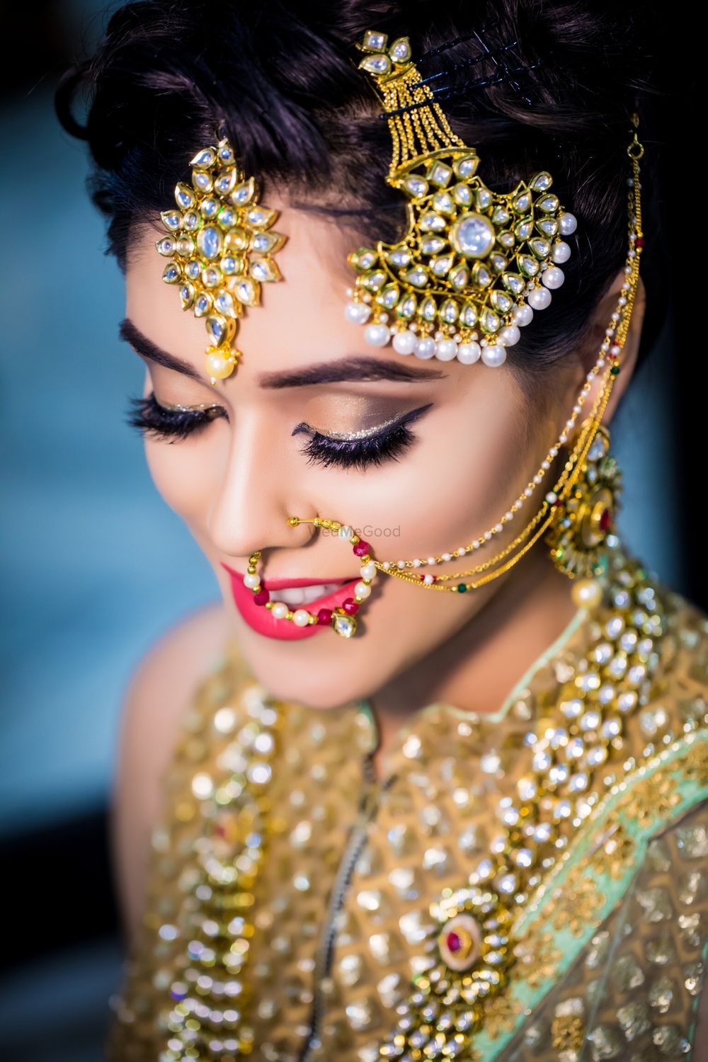 Photo of Bridal makeup with brown eyes and red lips with silver liner
