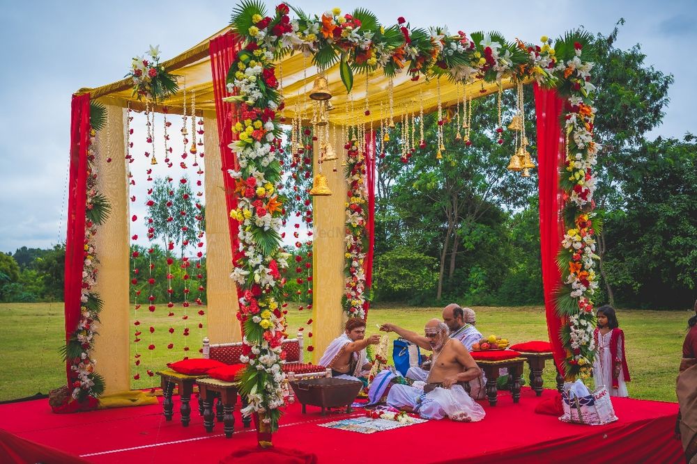 Photo of Red open air mandap with temple bells
