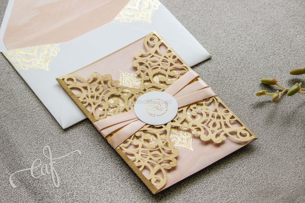 Photo of Blush and gold laser cut wedding invitation