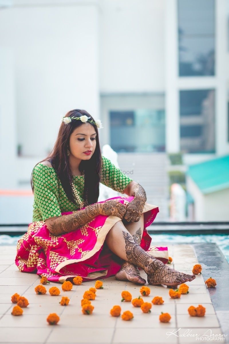 Photo of Bride with mehendi on hands and feet