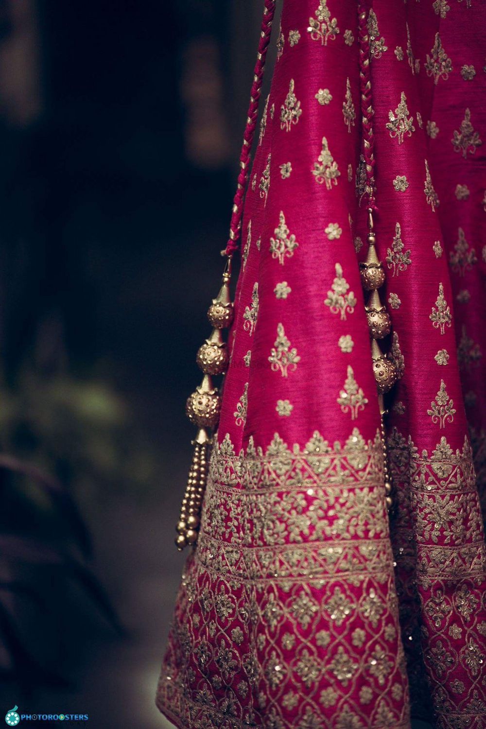 Photo of Simple pomegranate pink bridal lehenga with golden latkans