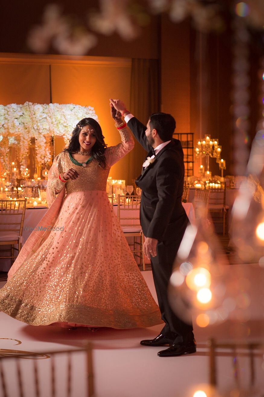 Photo of Cute groom twirling the bride shot