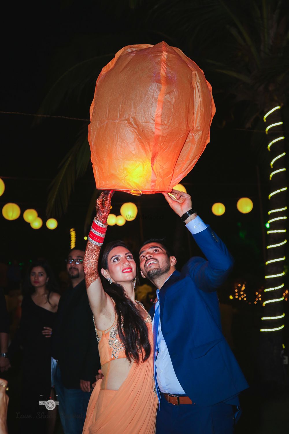 Photo of Couple releasing flying lantern together