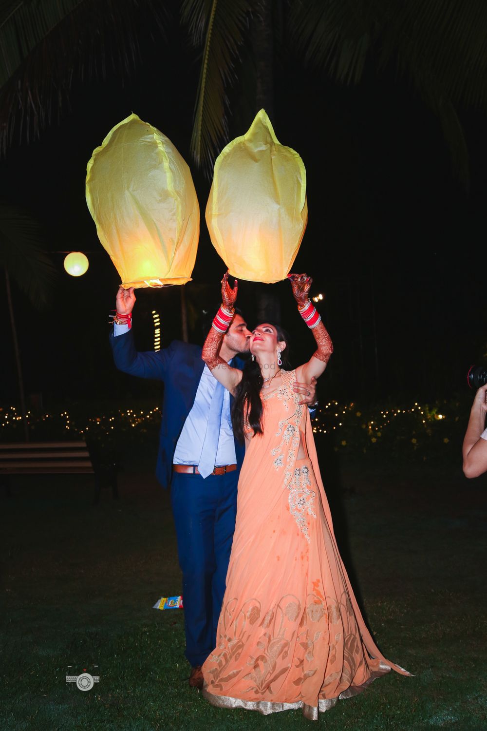 Photo of Couple releasing flying lantern on wedding