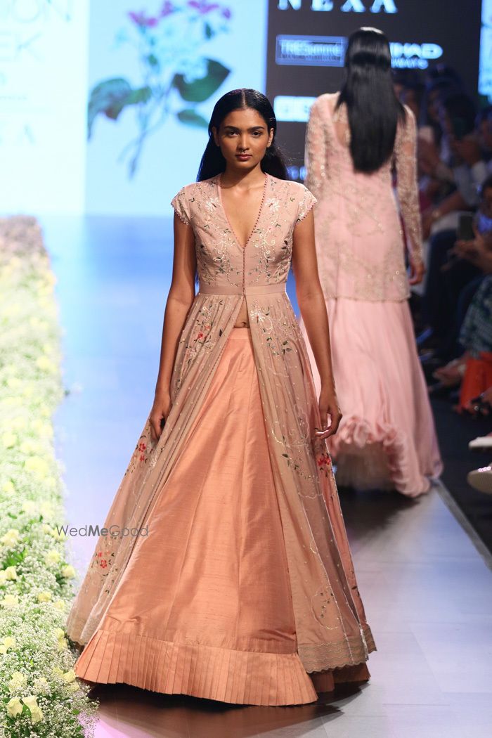 Photo of Peach lehenga with a floral printed jacket